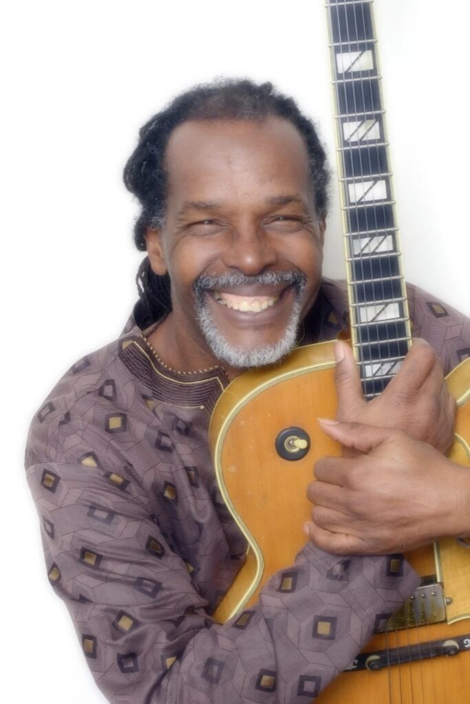 Maurice Gordon holding a classic archtop guitar