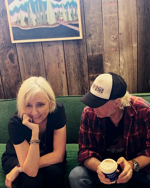 Jane Gowan and Joel Stewart of Foster Motel on a green couch